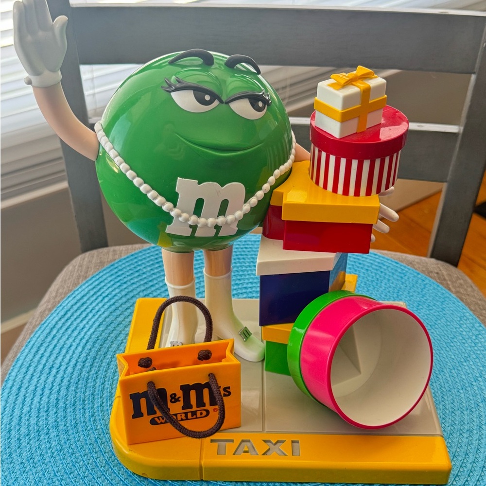 M&M Candy Dispenser - Green hailing a taxi